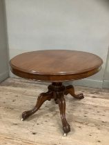 A mahogany Victorian oval topped Looe table on carved baluster support on four carved legs with