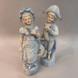 A pair of late 19th century continental pale blue figures of children dressed as a beau and