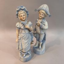 A pair of late 19th century continental pale blue figures of children dressed as a beau and