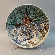 A20th century earthenware dish painted with the Garden of Eden, with Adam and Eve, the apple tree