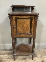 A Victorian walnut pot cupboard with mirrored back