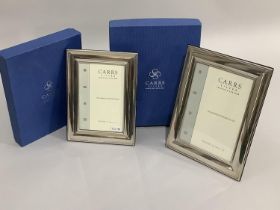 A pair of modern sterling silver photograph frames of graduated size, boxed, as new, 20cm x 15cm and
