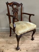 A mahogany Chippendale style carver chair with pierced back, scroll arms and carved cabriole legs on