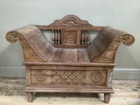 A fruitwood reproduction hall bench with scrolled arms carved back and base