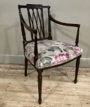 An Edward VII mahogany open armchair with trellis panel to the back, the seat upholstered in