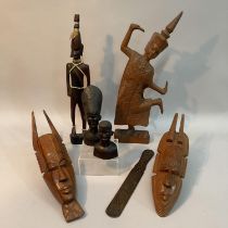 A carved wooden Thai figure of dancing girl, two carved African masks, an African carved tribesman