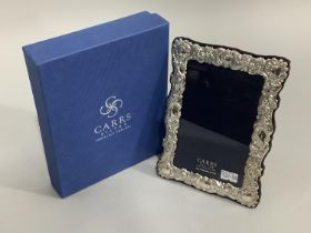 A modern sterling silver photography frame of embossed design by Carrs of Sheffield, boxed, as