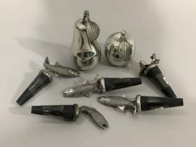 A set of five pewter fish mounted bottle stoppers and another with two frog finial, a polished