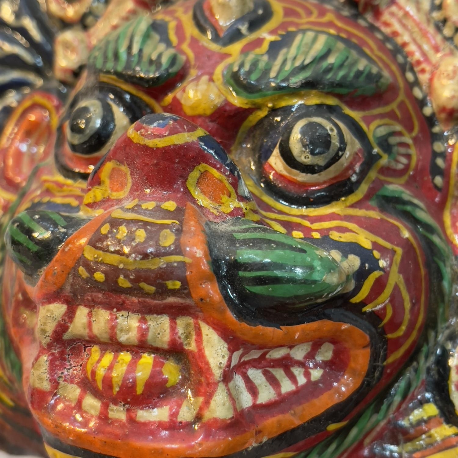 A Nepalese papier mache face mask painted in bright colours, a Mayan clay figure of a god seated and - Bild 2 aus 2