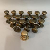 A collection of 19 brass door knobs