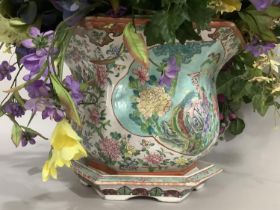 A modern Chinese pottery jardiniere enamelled with exotic bird and peony within a reserve against