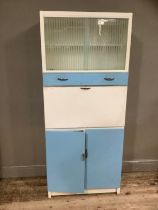 A mid century blue formica kitchen cabinet with glazed unit an drop down front