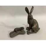 A bronze effect hare by Frith Sculpture, 29cm, together with a model of an otter upon a rock, 17.5cm