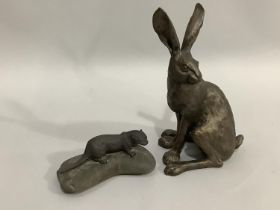 A bronze effect hare by Frith Sculpture, 29cm, together with a model of an otter upon a rock, 17.5cm