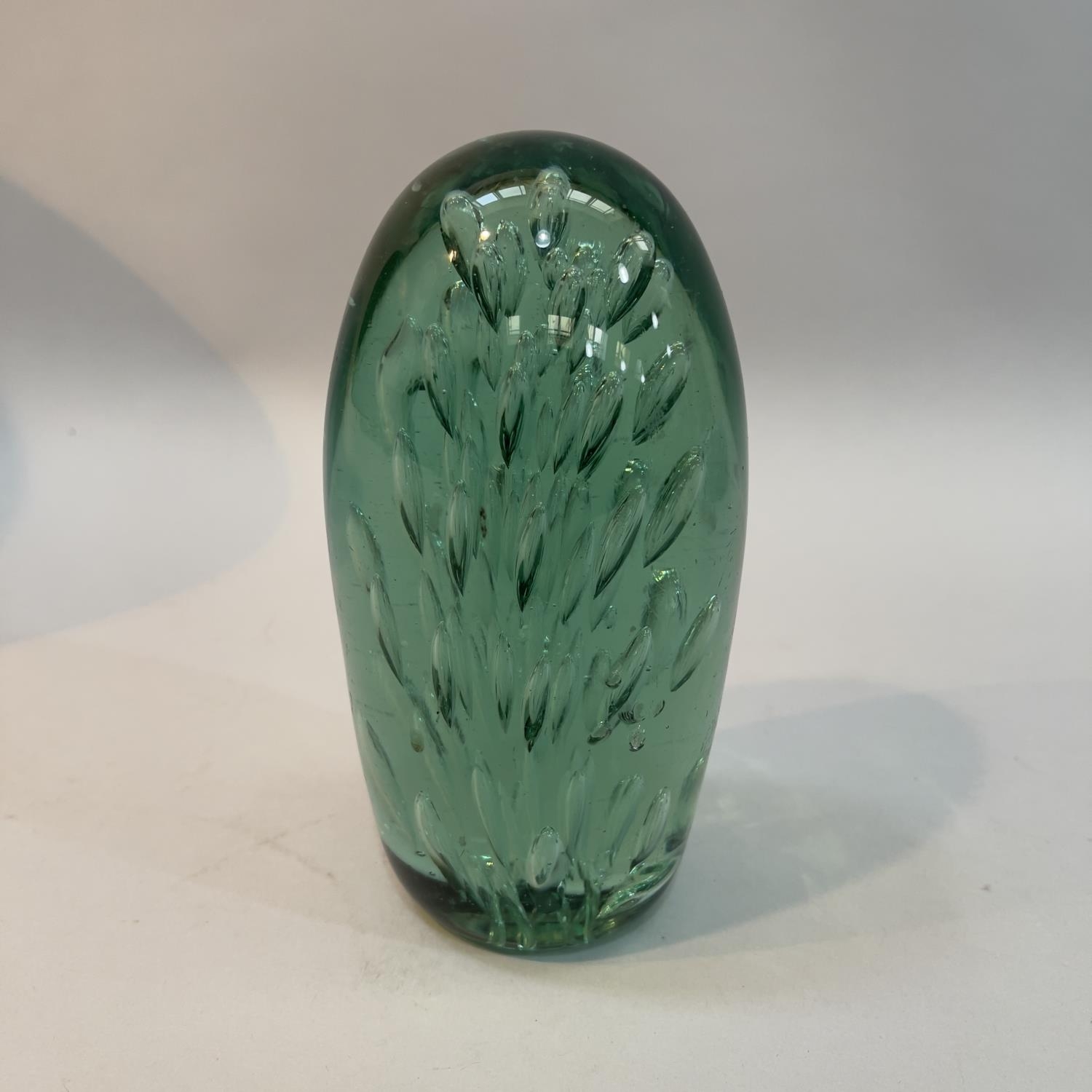 A 19th century green glass dump, internally with radiating tear drops, 17cm