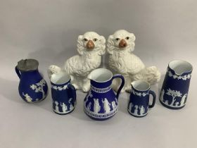 A pair of Staffordshire spaniels with painted features, a set of three Wedgwood Jasper ware jugs