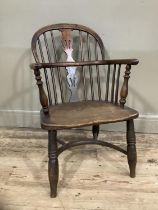 An elm Windsor chair with spindle and splat back on turned cut-down legs
