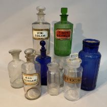 A collection of apothecary bottles comprising a green example Tinct Digitalis, a large clear