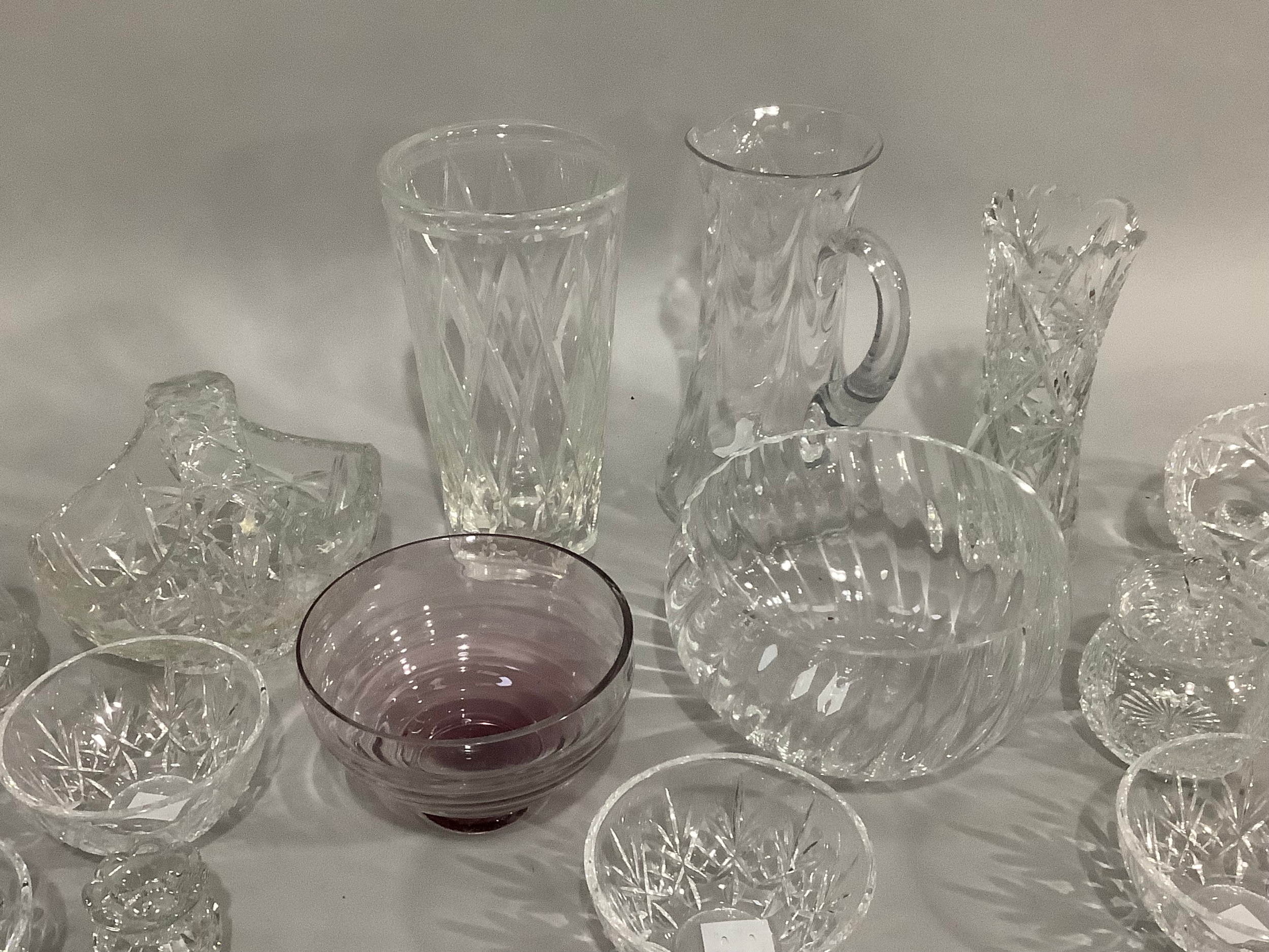 A Caithness amethyst glass bowl on foot,cut glass vases, trifle bowls, and other glassware