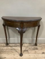 An early twentieth century mahogany card table with gadroon rim