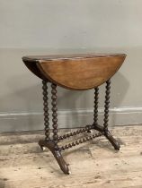 A mahogany drop leaf occassional table on bobbin legs and stretcher