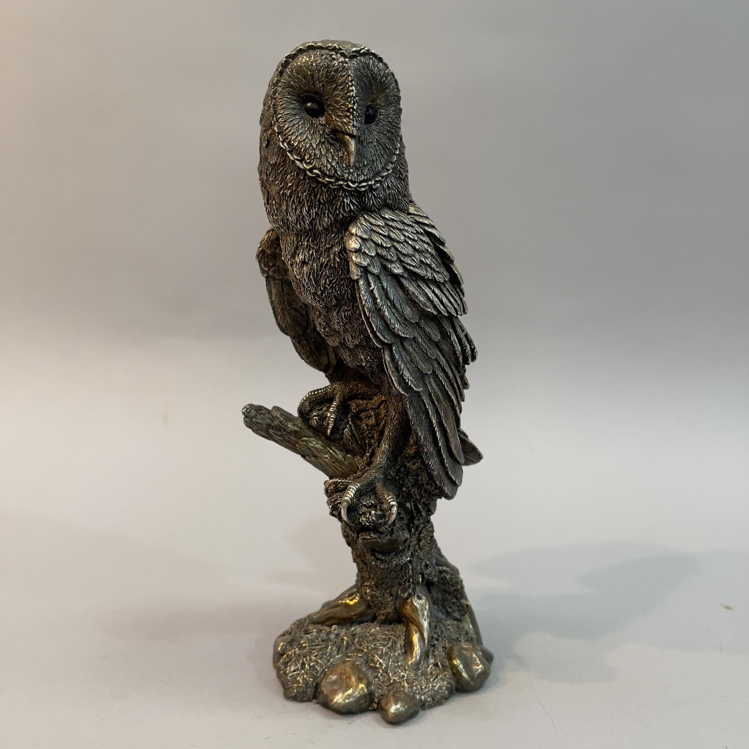 A filled white metal (tests as silver) model of a Barn Owl by Country Artists, modelled on a branch,