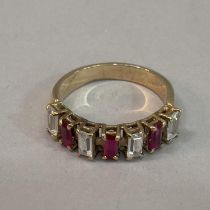 A half loop dress ring claw set with baguette cut synthetic rubies and colourless spinels in