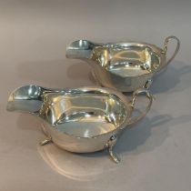 A pair of George V silver sauce boats, Sheffield 1933 for Viners Ltd, each with scalloped rim, on