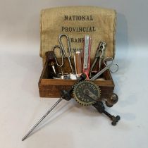 An Anders Mattson Mora patent bobbin winder together with a box of small tools including