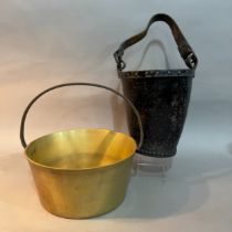 A leather fire bucket lined with tin, leather strap, crest to front (faded), and a 19th century