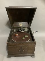 A His Masters Voice portable record player, with tin of needles