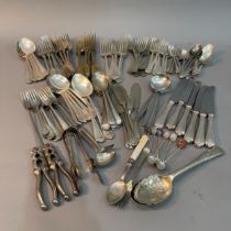 A collection of silver plated and stainless steel cutlery comprising forks, soup spoons, serving