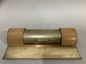 An Art Deco brass desk stand, of semi-circular form, having a central teak lined compartment with