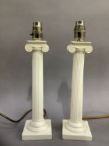 Two cream ceramic table lamps formed as colums on stepped bases