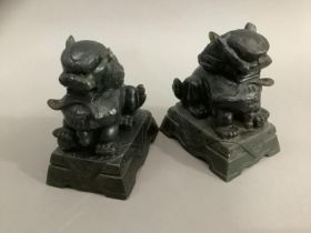 A pair of carved green soapstone temple lions on plinths, 10cm high