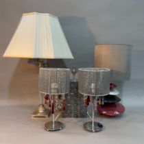 Five decorative table lamps including a pair with prismatic drops, a metal woven example, a tall