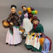A Royal Doulton 'The Old Balloon Seller' 23cm high, 'The Orange Lady' 22cm high, 'Silks and Ribbons'