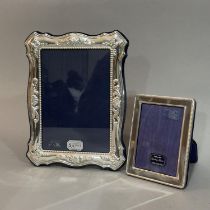 Two modern sterling silver photograph frames of graduated sizes, boxed as new, 18cm x 14cm and 10.
