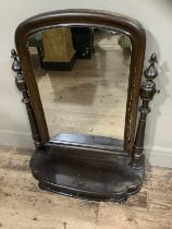 A mid 19th century toilet mirror, arched glass on turned supports with a drawer to the platform