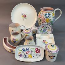 A collection of Poole pottery comprising a jug painted with flowers BN pattern, preserve pot and