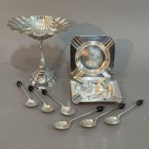 A silver plated bonbon dish modelled as a dolphin supporting a shell, two silver plated ashtrays and