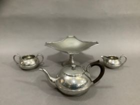 A Civic pewter planished tea service comprising a teapot, milk jug, twin handled sugar bowl together