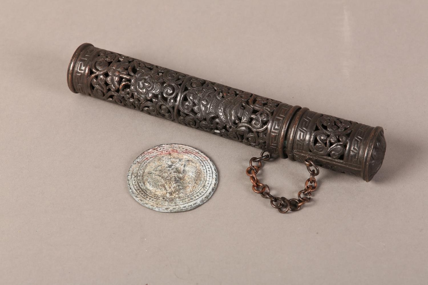A TIBETAN COPPER INCENSE HOLDER of cylindrical, form and pierced scrolling tendrils, 21cm long
