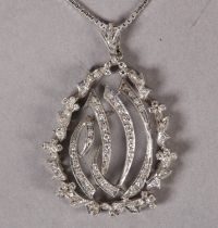 A DIAMOND PENDANT c1970, the eight cut diamonds grain and claw set to the Islamic inscription within