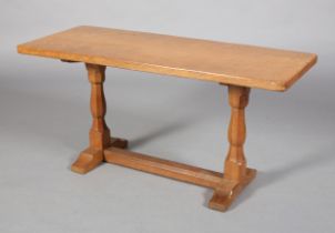 AN OAK COFFEE TABLE, Eagleman, rectangular, on octagonal turned refectory standards joined by a