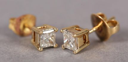 A PAIR OF DIAMOND STUD EARRINGS IN 18ct gold, each claw set with a Princess cut stone on post