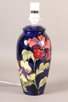 A MOORCROFT LAMP, of baluster form, painted with yellow and purple hibiscus blooms and foliage, 35cm