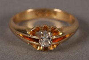 A GEORGE V SINGLE STONE DIAMOND RING in 18ct gold, the old mine cut stones claw set in a carved