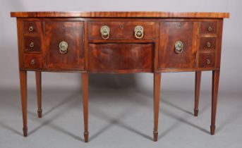 A GEORGE III STYLE MAHOGANY AND CROSSBANDED BOW FRONTED SIDEBOARD, having a drawer and serpentine