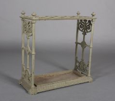 A CAST IRON UMBRELLA STAND with fretwork end panels and four knopped corners, 62cm x 61cm